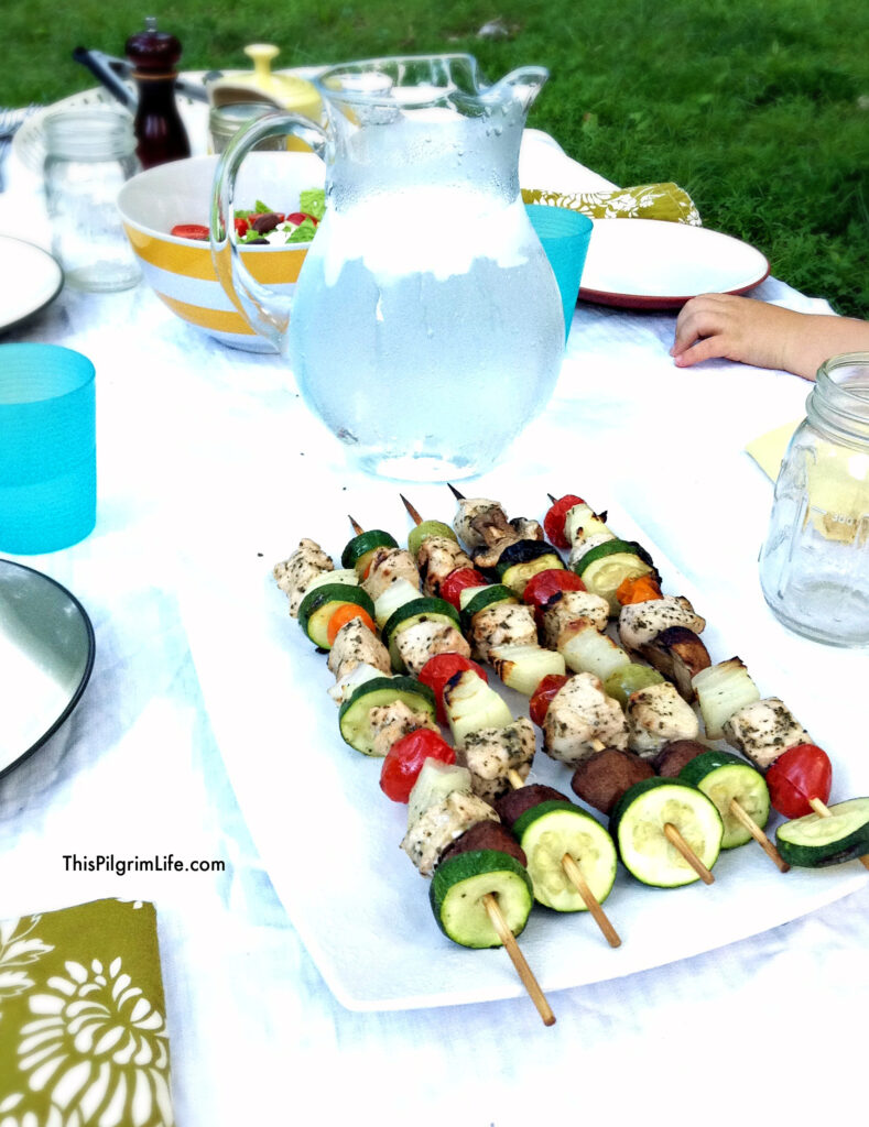 Greek chicken kabobs eaten outside for a family dinner
