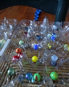 Make a fun ski ball game using a pool noodle, marbles, and a few small bowls!