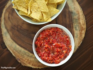 This homemade fresh salsa is seriously amazing! It's chunky and full of flavor-- and only takes about five minutes to make! We love this salsa on chips, nachos, tacos, quesadillas, soups, and more-- no wonder it doesn't last long!