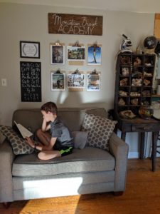 This is our current homeschool organization in our dining room. We have five kids and an average sized house, but everything is still neat, tidy, and inviting! Plus, check out a mega list of our favorite homeschool resources, and get a few free printables for your homeschool space! 